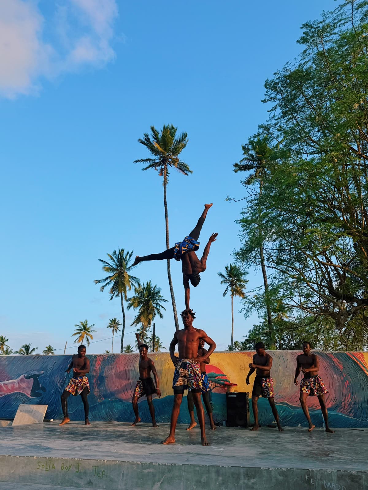 A Move Zanzibar acrobat balancing in a handstand on a teammate's shoulder, on the beach in Jambiani A Move Zanzibar acrobat balancing in a handstand on a teammate's shoulder, on the beach in Jambiani